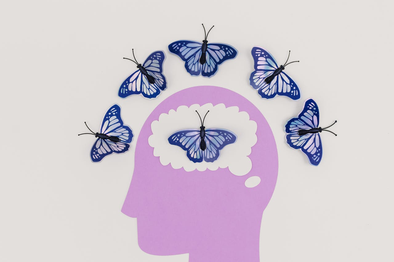 gallery-4 Creative illustration of butterflies representing thoughts over a brain silhouette.